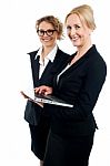 Two Corporate Women Working On Laptop Stock Photo