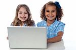 Two Cute Little School Girls With Laptop Stock Photo