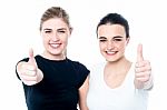 Two Girls Cheering Via With Thumbs Up Gesture Stock Photo