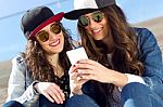 Two Girls Having Fun With Smartphones Stock Photo