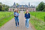 Two Girls Walking Away From Castle Stock Photo