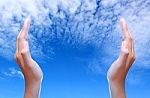 Two Hands Over Blue Sky Stock Photo