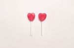 Two Pink Valentine's Day Heart Shape Lollipop Candy On Empty White Paper Background. Love Concept. Knolling Top View. Minimalism Colorful Hipster Style Stock Photo