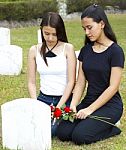 Two Sad Girls At A Grave Stock Photo