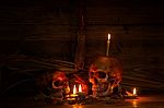 Two Skull Still Life With Knife In Dark Scene For Halloween Nigh Stock Photo