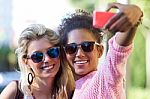 Two University Girl Students Taking A Selfie In The Street Stock Photo