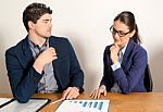 Two Young Business People Discussing Stock Photo
