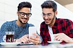 Two Young Entrepreneurs Working At Coffee Shop Stock Photo