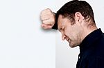 Unhappy Man Leaning At The Wall Stock Photo