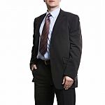 Unrecognizable Businessman In Suit Standing With Hand In Pocket Stock Photo