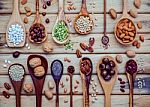 Various Legumes And Different Kinds Of Nutshells In Spoons. Waln Stock Photo