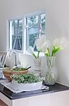 Vase Of Flower On Counter In Kitchen Room Stock Photo