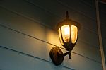 Warm Light Of External Lamps On The House Wall Stock Photo
