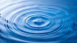 Water Drop Falling Into Water Making A Perfect Droplet Splash Stock Photo