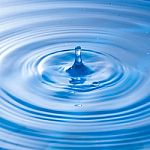 Water Drop Falling Into Water Making A Perfect Droplet Splash Stock Photo
