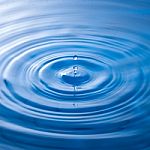 Water Drop Falling Into Water Making A Perfect Droplet Splash Stock Photo