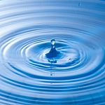 Water Drop Falling Into Water Making A Perfect Droplet Splash Stock Photo