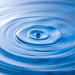 Water Drop Impact With Water Surface, Causing Rings On The Surface Stock Photo