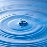 Water Drop Impact With Water Surface, Causing Rings On The Surface Stock Photo