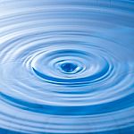 Water Drop Impact With Water Surface, Causing Rings On The Surface Stock Photo