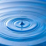 Water Drop Impact With Water Surface, Causing Rings On The Surface Stock Photo