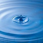 Water Drop Impact With Water Surface, Causing Rings On The Surface Stock Photo