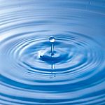 Water Drop Impact With Water Surface, Causing Rings On The Surface Stock Photo