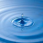 Water Drop Impact With Water Surface, Causing Rings On The Surface Stock Photo