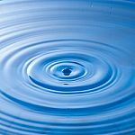 Water Drop Impact With Water Surface, Causing Rings On The Surface Stock Photo