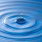 Water Drop Impact With Water Surface, Causing Rings On The Surface Stock Photo