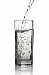 Water Pouring Into A Tall Glass With Its Reflection, Closeup Vie Stock Photo