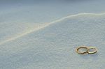 Wedding Rings In The Snow Stock Photo