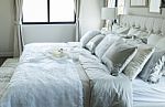 White And Grey Pillow On Bed Stock Photo