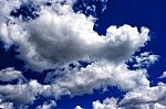 White Clouds In The Bright Blue Sky Stock Photo