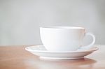 White Coffee Cup On Wooden Table Stock Photo