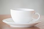 White Coffee Cup On Wooden Table Stock Photo