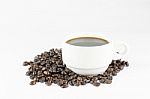 White Cup Of Coffee On Beans Stock Photo