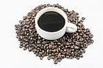 White Cup Of Coffee On Beans Stock Photo