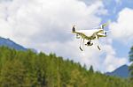 White Drone Flying Above Mountains Stock Photo
