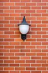 White Lamp Red Brick Wall Stock Photo