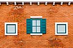 Window On The Orange Brick Wall Stock Photo