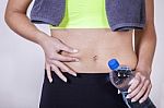 Woman After Fitness Training, Pinches Fat On The Belly Stock Photo