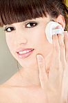 Woman Applying Make Up With Cosmetic Sponge Stock Photo