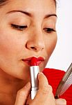 Woman Applying Red Lipstick Stock Photo