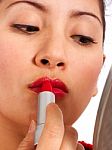Woman Applying Red Lipstick Stock Photo