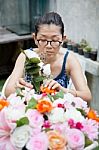 Woman Arranging Artificial Flower In Wood Box Stock Photo
