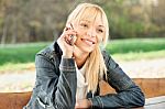 Woman At Park Taking A Phone Call Stock Photo