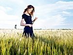 Woman At Wheat Field On Sunny Day Stock Photo
