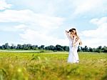 Woman At Wheat Field On Sunny Day Stock Photo