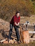 Woman Working With An Axe And Chainsaw Stock Photo